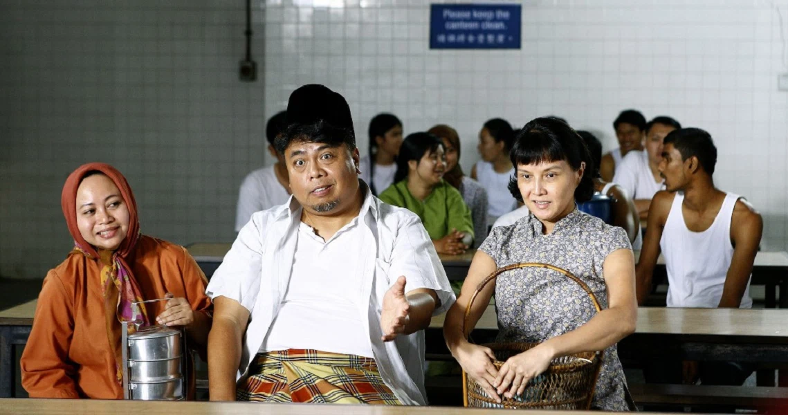 A film still from "A Long Long Time Ago" showing three people sitting in a crowded waiting area, likely a government office or clinic.