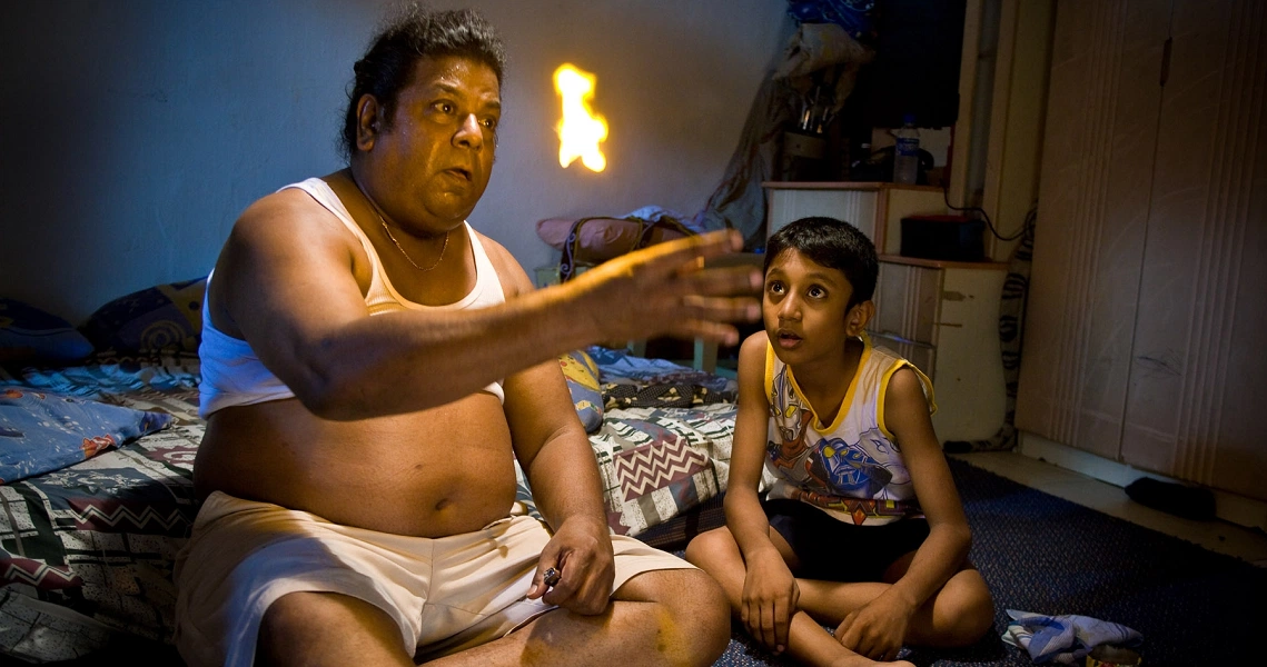 A scene from the Singaporean film 'My Magic' showing a father and son in a tender moment, highlighting family bonds.