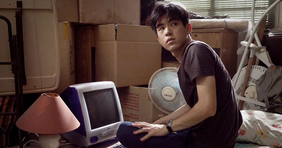 A scene from the Singaporean film 'Sandcastle', showing a contemplative moment between characters in a domestic setting.