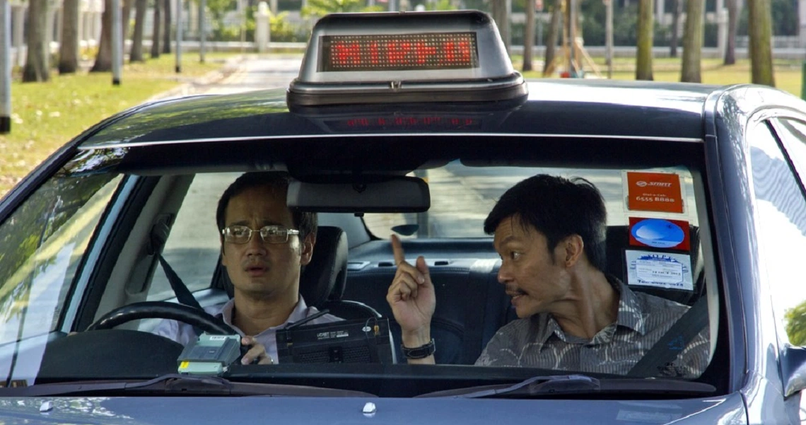 A scene from the Singaporean film 'Taxi! Taxi!' showing a taxi driver in his vehicle, highlighting urban life in Singapore.